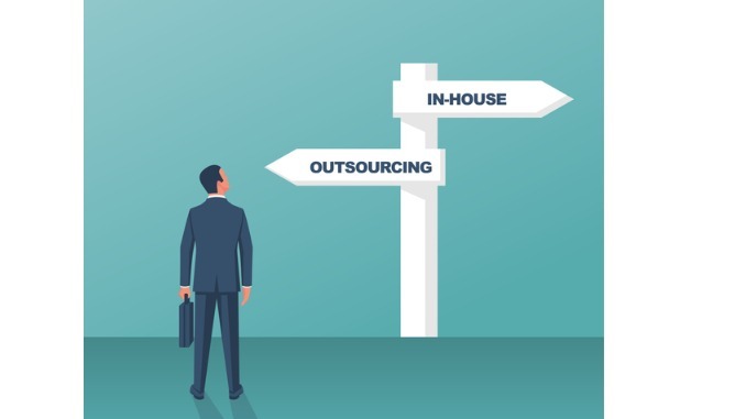 outsource-or-inhouse-signpost-businessman-in-front-of-a-road-sign.