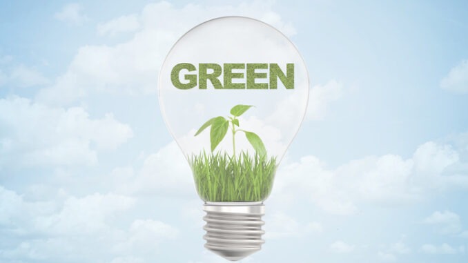 3d rendering of "GREEN" sign over small green sprout inside a light bulb on blue sky background