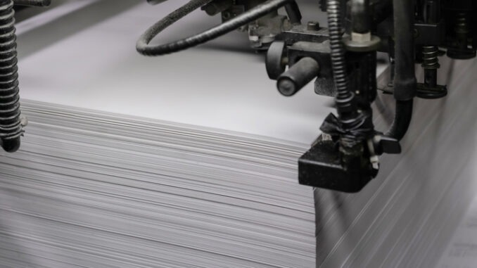 Printed sheets of paper are served in the printing press offset printing