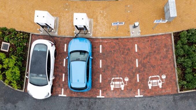 Aerial view directly above electric car being charged