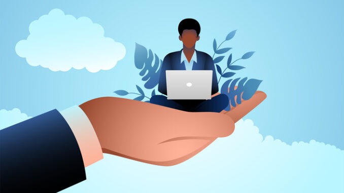Giant hand holding a businessman who works on laptop,