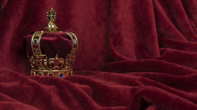 Golden crown on a red velvet background