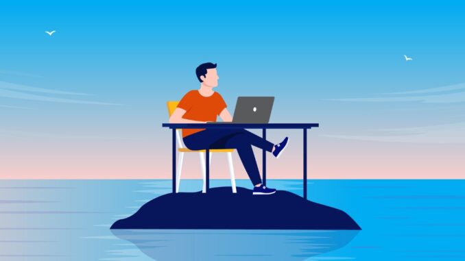 Man sitting at desk with computer alone on deserted island in solitude, peace and quiet