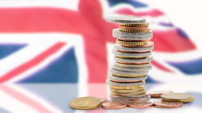 Coins stacked near union Jack