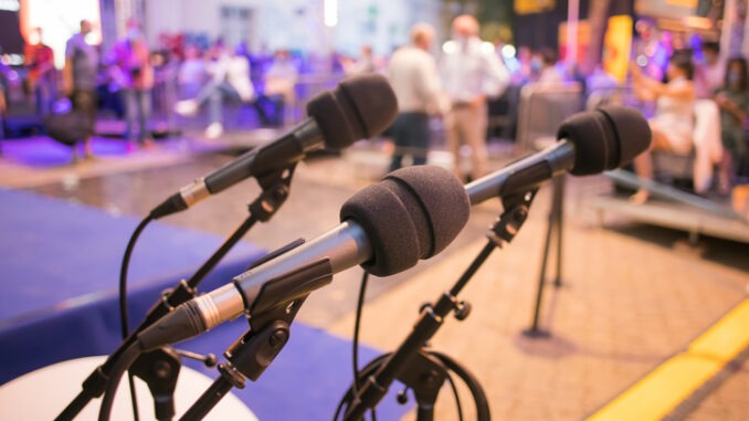 three microphones ready at a seminar event