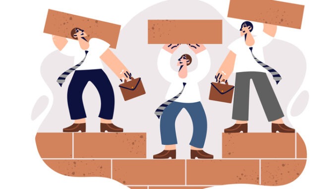 Teamwork of business men building wall of bricks together and taking care of creating successful corporation. 