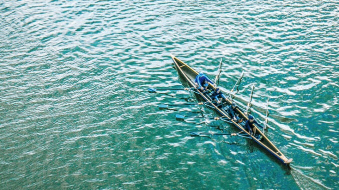 High Angle View Of People Rowing Boat On Sea