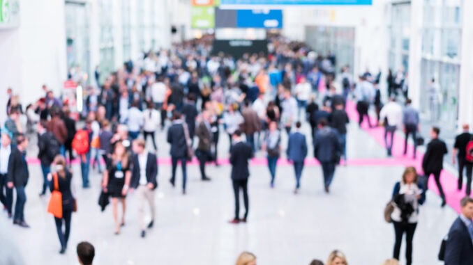 blurred anonymous people walking in a modern hall