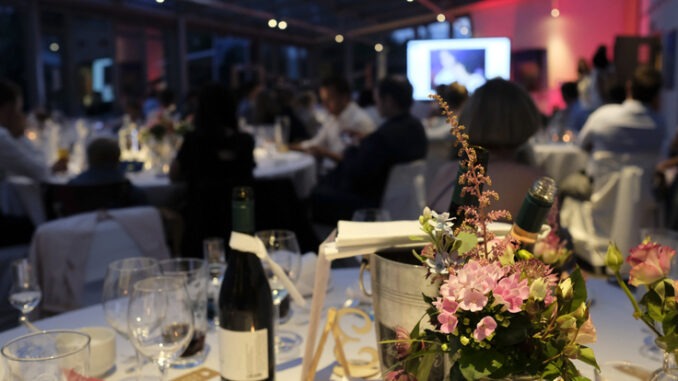 Evening event with flowers and wine bottles on the tables