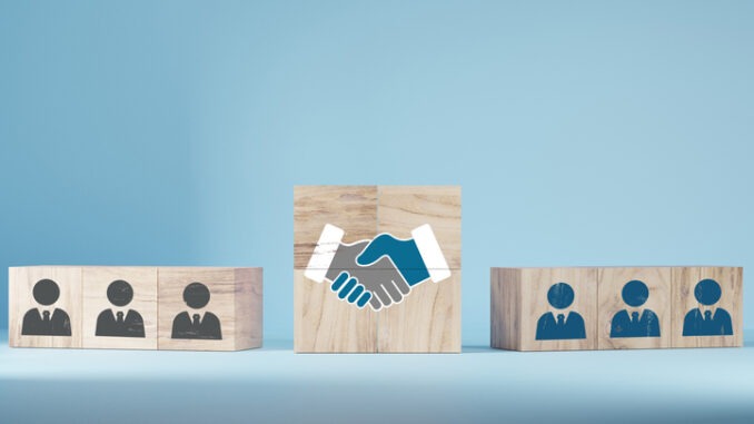 hand shaking icon on wooden cube blocks and human in circle icon for business deal 