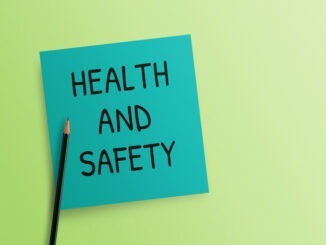 Writing note showing Health and Safety on green background.