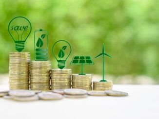 lternative or renewable energy financing program, financial concept : Green eco-friendly or sustainable energy symbols atop five coin stacks e.g a light bulb, a rechargeable battery, solar cell panel
