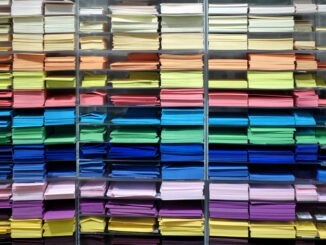 Shelf with many professional colorful sheets of paper