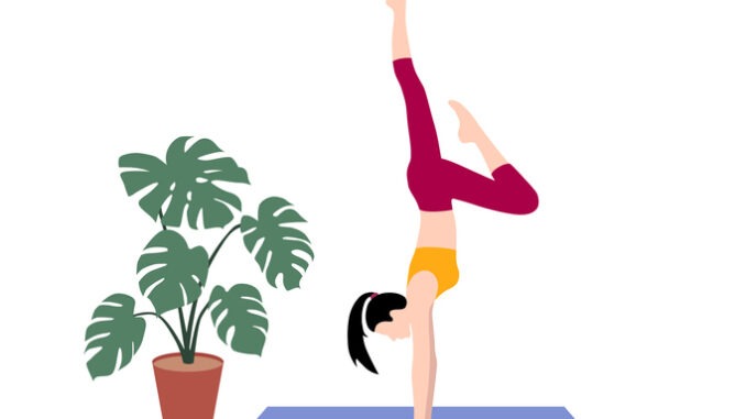 young slim woman exercising yoga. Handstand pose