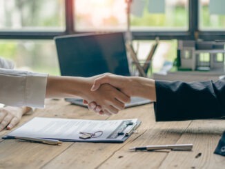 Employer shakes hands to acquaint female job applicant interviewing candidate after successful meeting recruitment concept