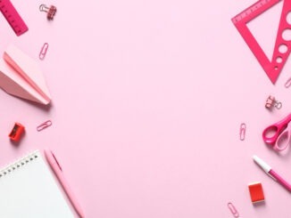 Pink office supplies on pink background.