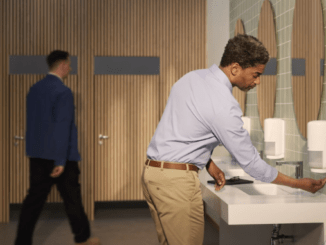 Employee using clean and hygienic office washroom
