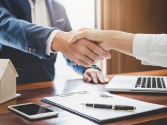 dealer and customers shaking hands together celebrating finished contract after about home insurance and investment loan, handshake and successful deal