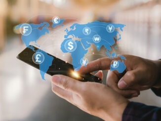 Man holding a smartphone to do online financial transactions for overseas spending. Work in the global financial market via mobile device. money transfer and exchange, global currency concepts.