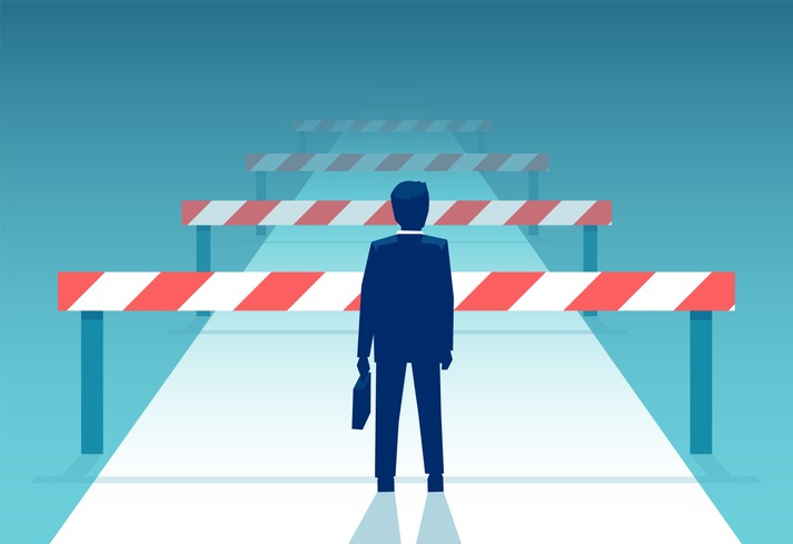 Vector of a challenged businessman standing in front of many obstacles and barriers on the way to success.