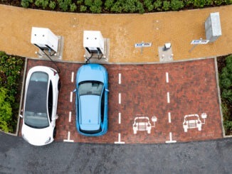 Aerial view directly above electric car being charged
