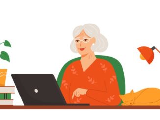 Happy older lady working on a laptop at home