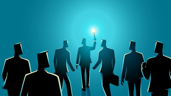 Business concept of a businessman with torch leading another businessmen behind him,