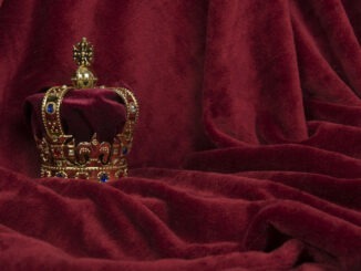 Golden crown on a red velvet background