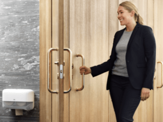 smiling employee opening bathroom door