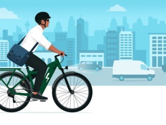 Business man riding an eco-friendly electric bike in the city street, sustainable mobility concept