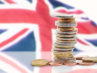 Coins stacked near union Jack