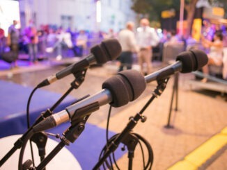 three microphones ready at a seminar event