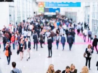 blurred anonymous people walking in a modern hall