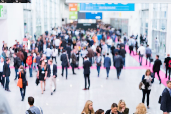 blurred anonymous people walking in a modern hall