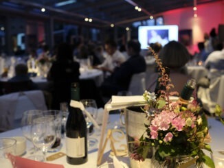 Evening event with flowers and wine bottles on the tables