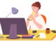 Woman eating lunch at computer desk. Office meal break