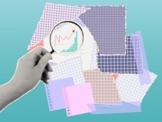 Businessman viewing a graph through a magnifying glass,