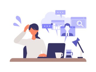 Multitasking businesswoman working on computer.